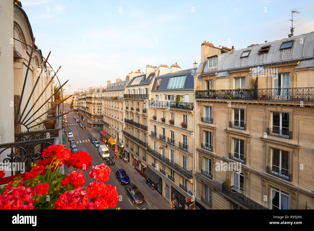 Paris, ancient buildings facades and street in a warm summer sunset in France Stock Photo