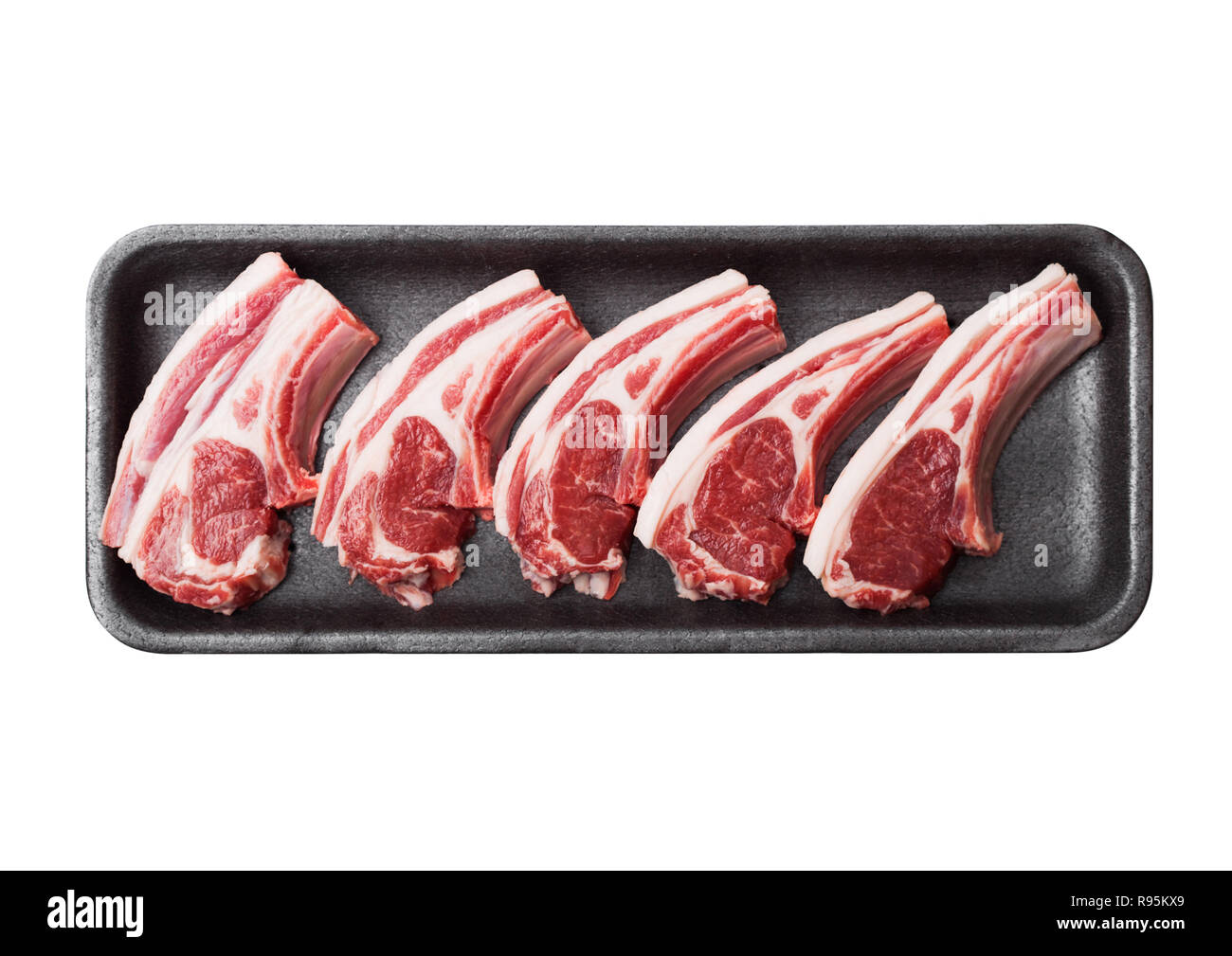 Fresh raw butchers lamb beef cutlets in plastic tray on white. Stock Photo