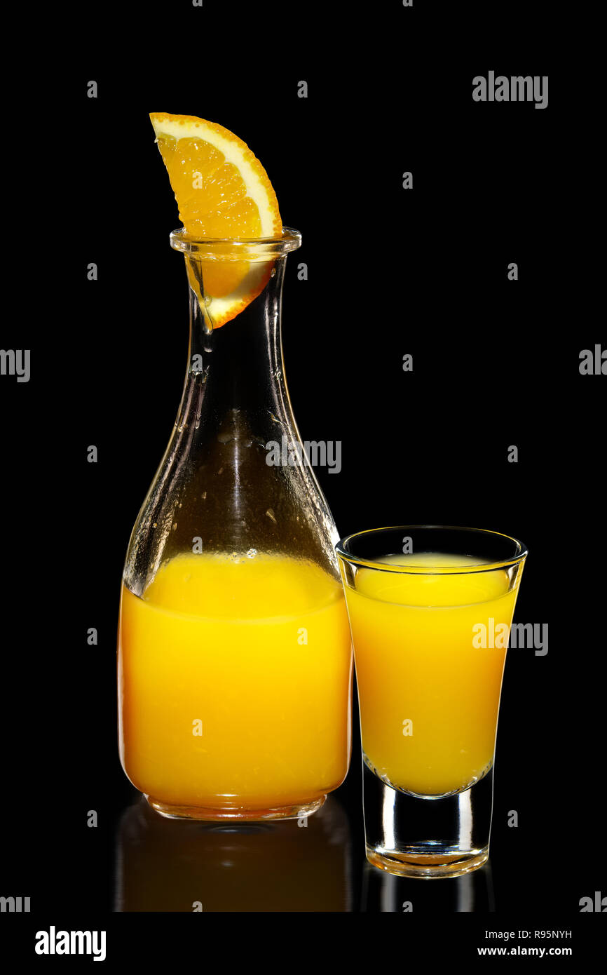 Fresh orange juice as ingredient for vodka cocktail isolated on black Stock Photo