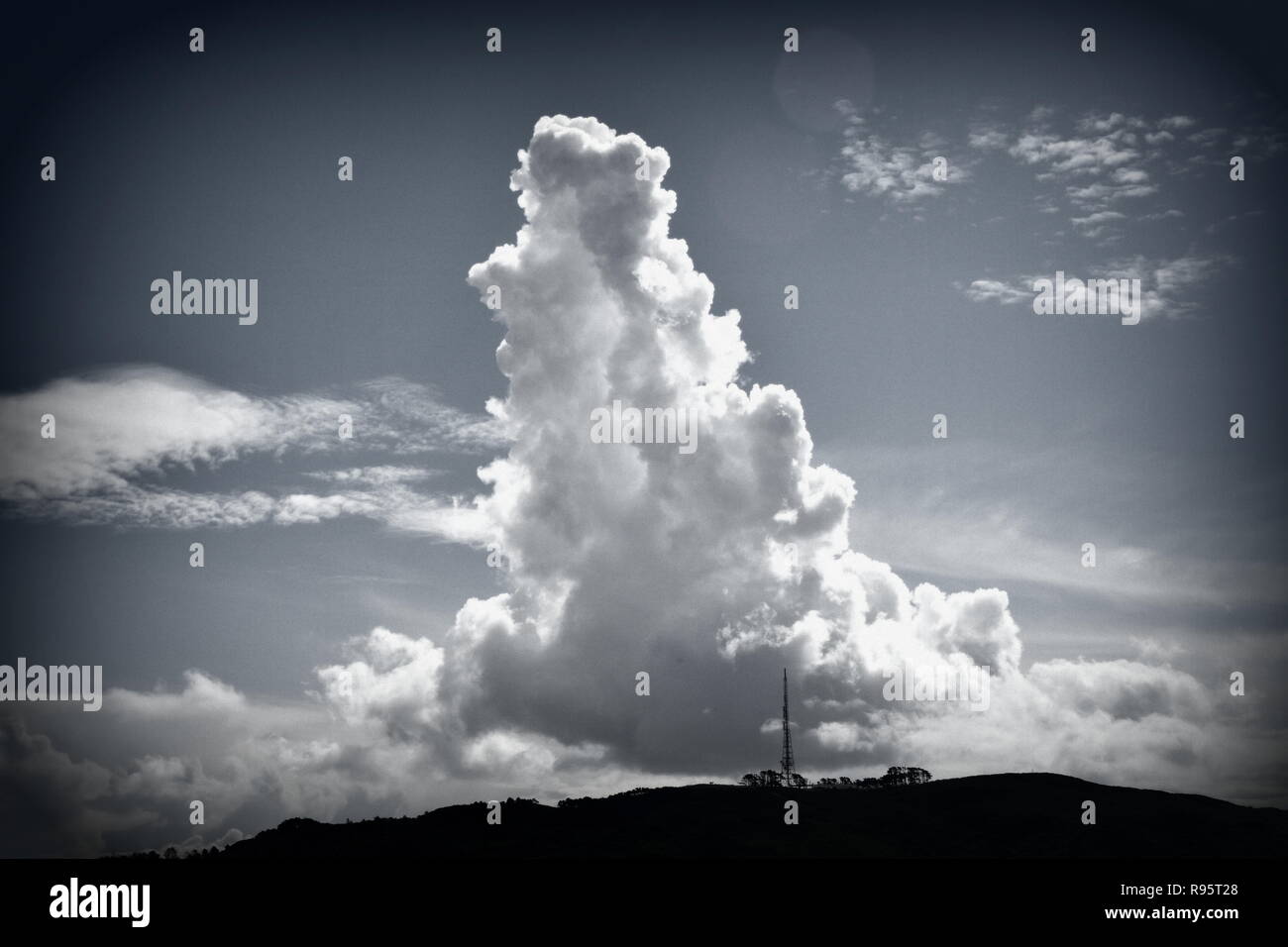 Towering cumulus cloud mimics the tv tower on Mt Kaukau, Wellington Stock Photo