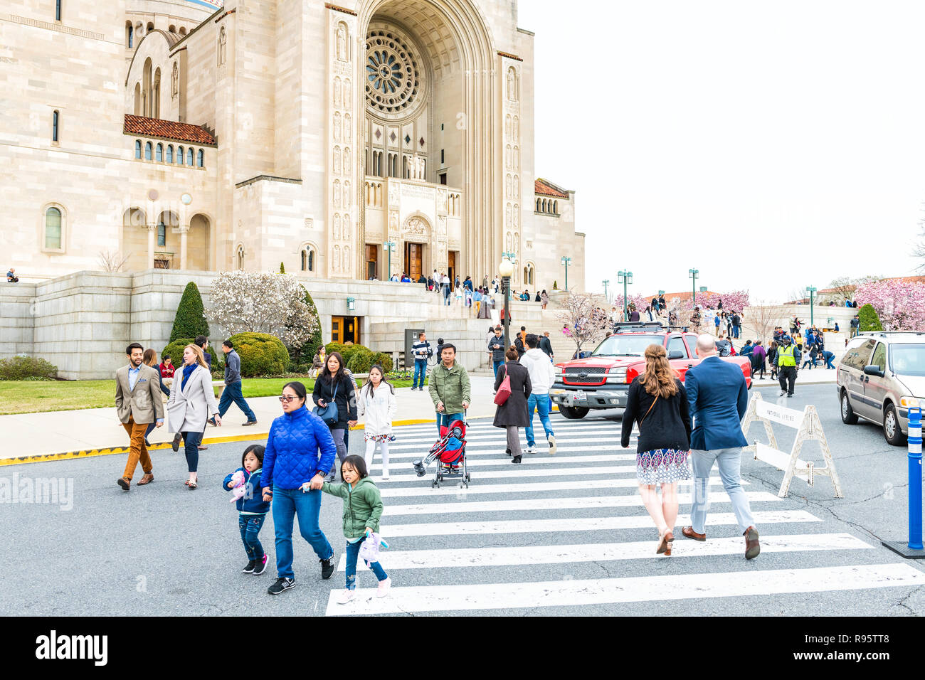 Washington DC, USA - April 1, 2018: People, family, mother, children walking by basilica of the National Shrine of the Immaculate Conception Catholic  Stock Photo