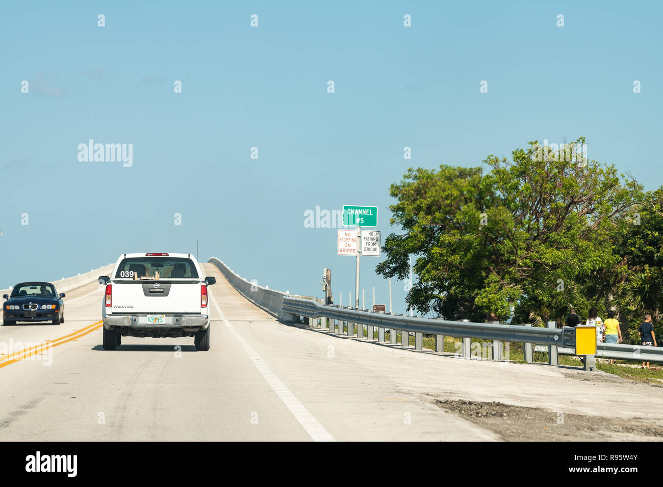 Lower Matecumbe Key, USA - May 1, 2018: Channel number five # 5 bridge, passage sign at Florida keys with overseas highway road, cars driving, moving, Stock Photo