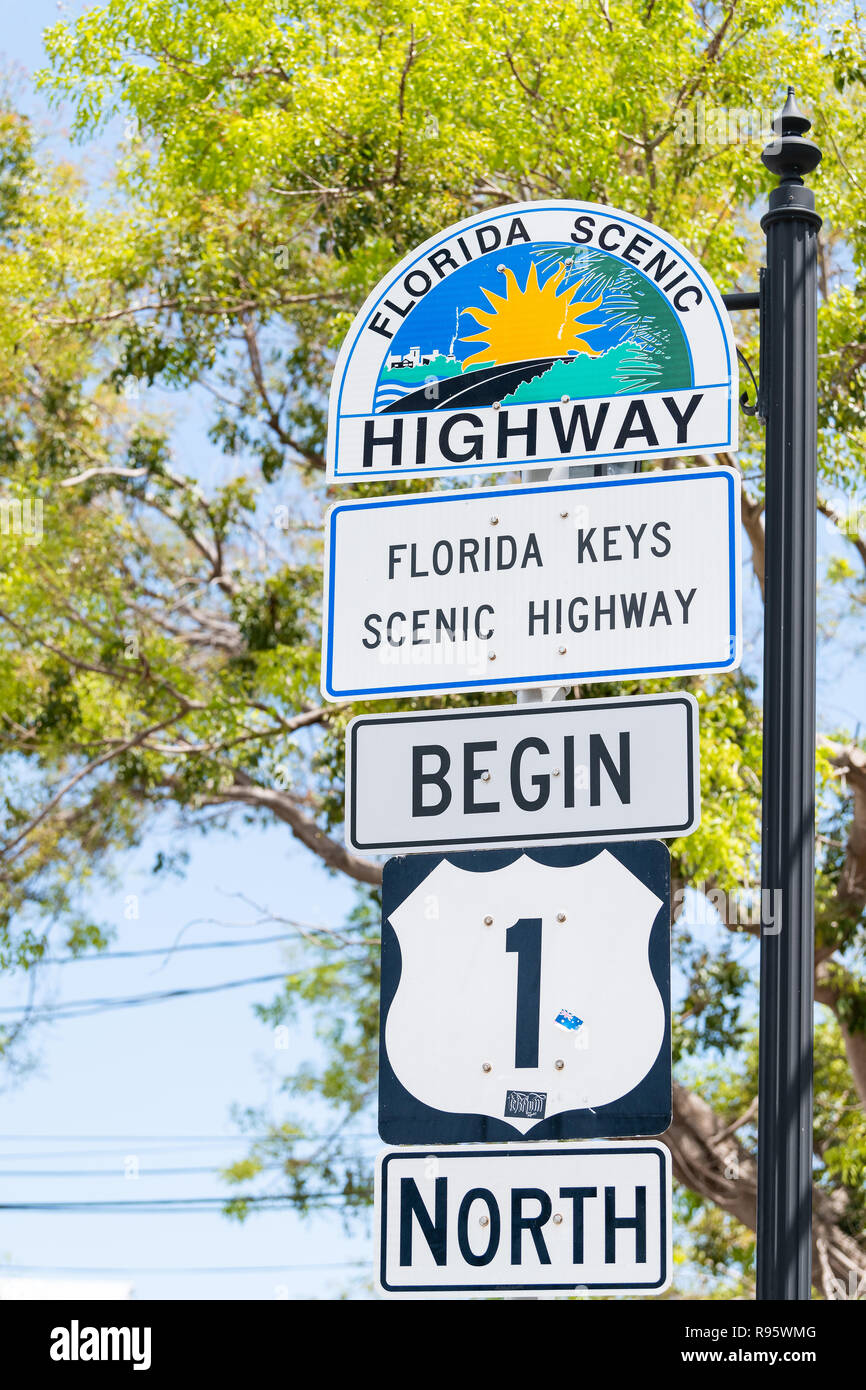 Key West, USA - May 1, 2018: Florida scenic highway, keys begin US1, US one, 1, North route, road street, overseas hwy, freeway sign with art painting Stock Photo