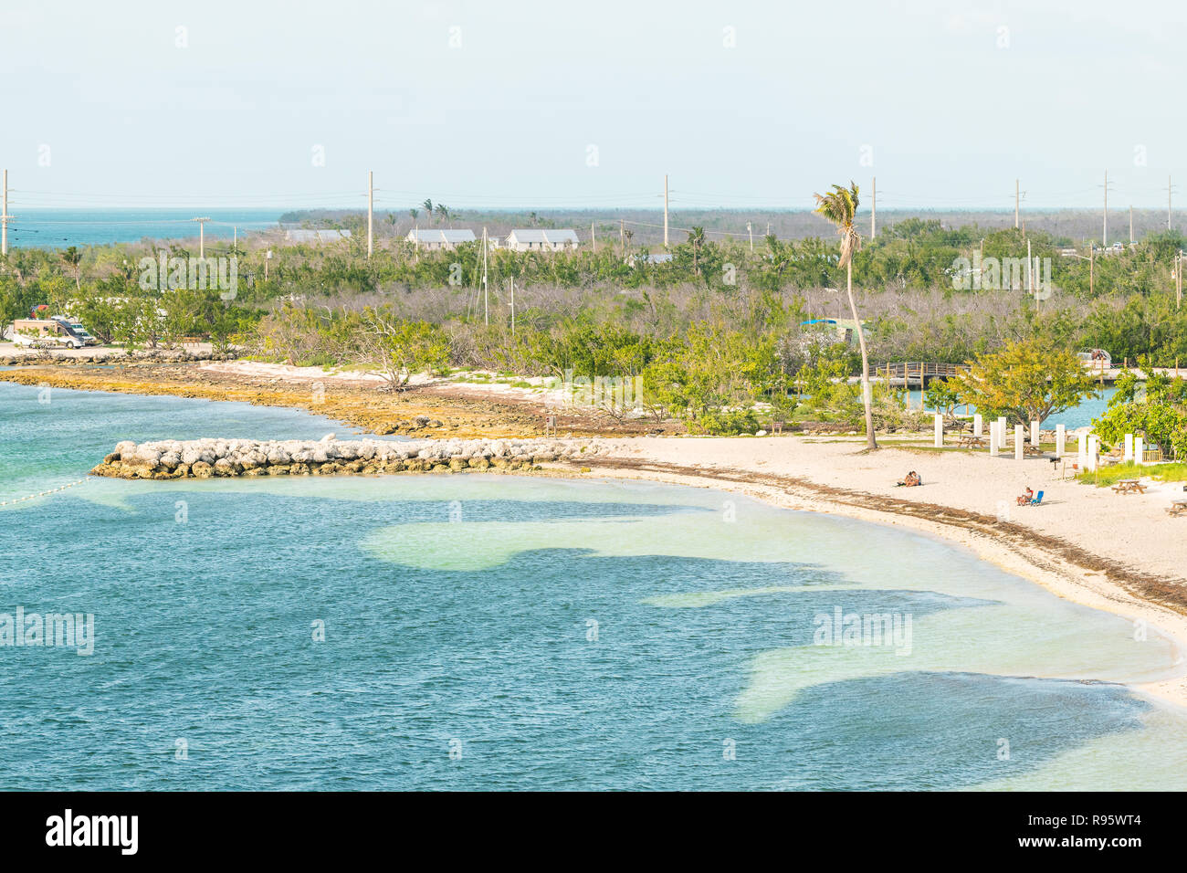 Bahia Honda Key, USA - May 1, 2018: Florida state park in island with shore, coast, sand beach, people sitting on chairs after hurricane irma destruct Stock Photo