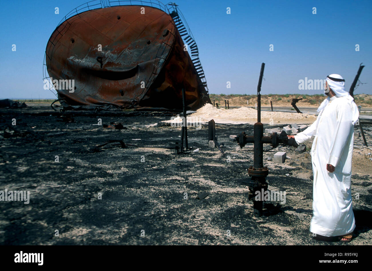 Melted oil storage tank and spill damage from the Gulf War in Kuwait 1990 Stock Photo