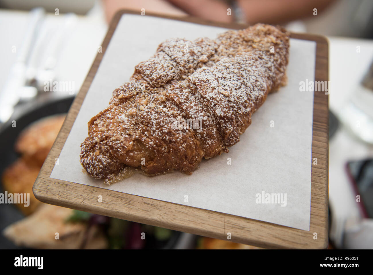 Image of very delicious and tasty baked croissant served at Ottolenghi restaurant in UK. The food seems to be very delicious and looks very fresh. Stock Photo