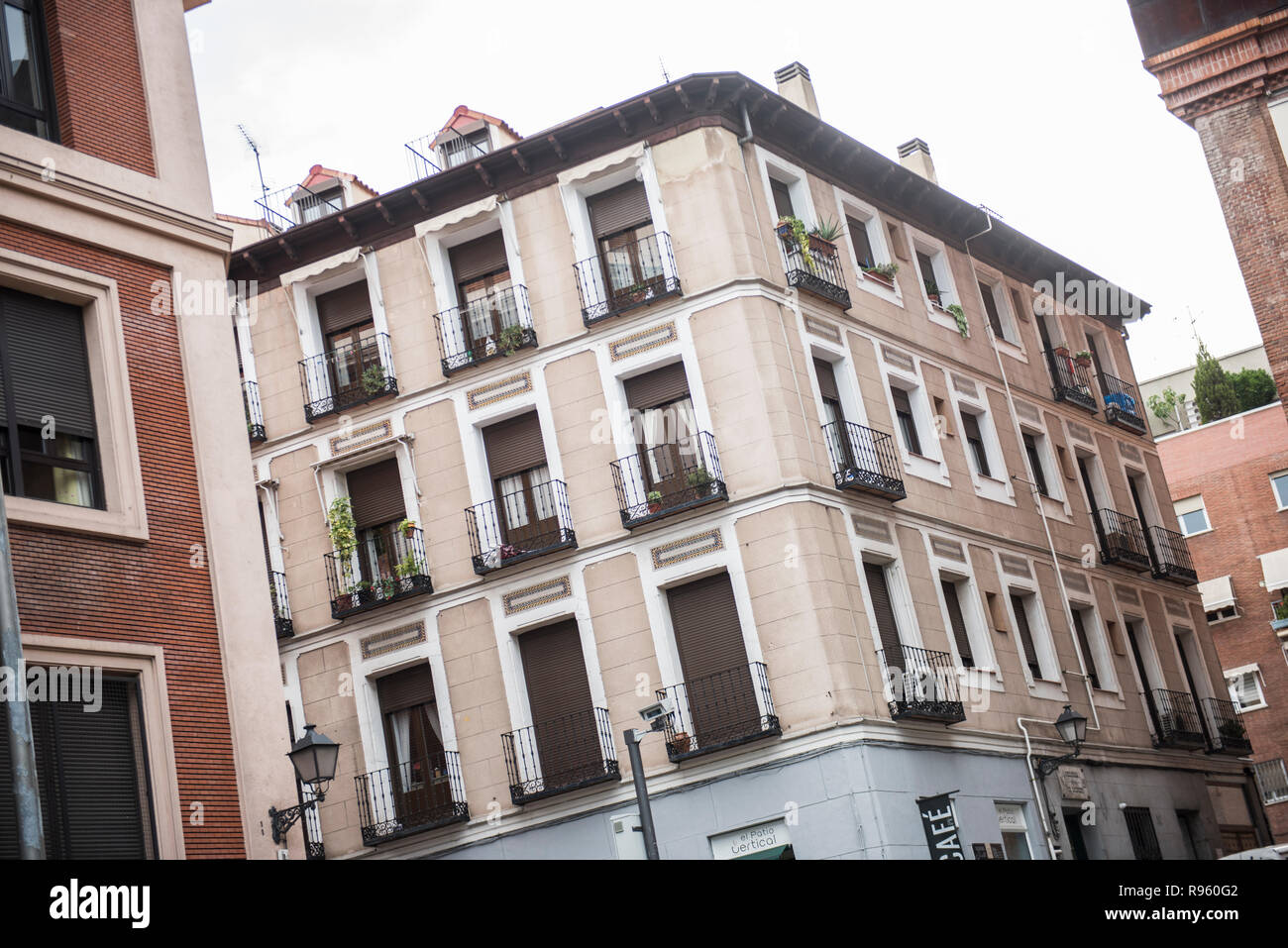 Exterior of a local building in Spain. The building seems to be a mix of old and modern architecture. The Streets seem to be narrow. It seems to be a  Stock Photo