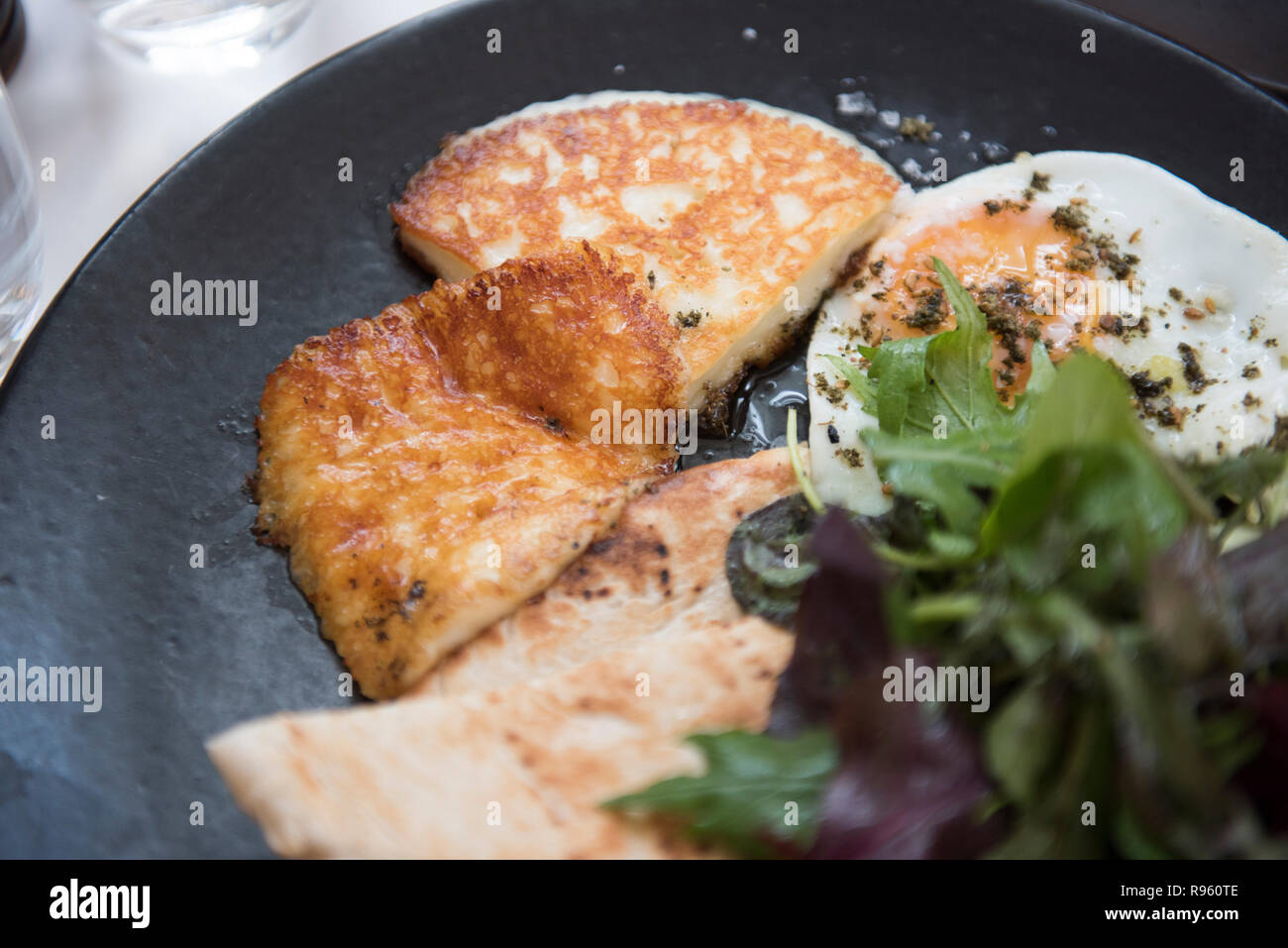 Image of very delicious and tasty eggs and cheese breakfast seen being served at Ottolenghi restaurant. The food seems to be very delicious and looks  Stock Photo