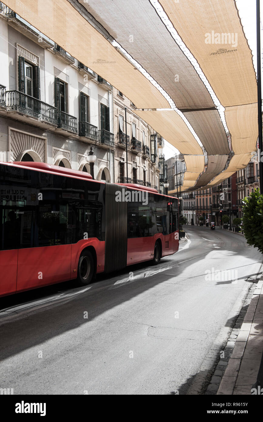 A local transportation bus is seen in the city. Bus is a regular form of transportation and carried thousands of people daily. On the background, buil Stock Photo