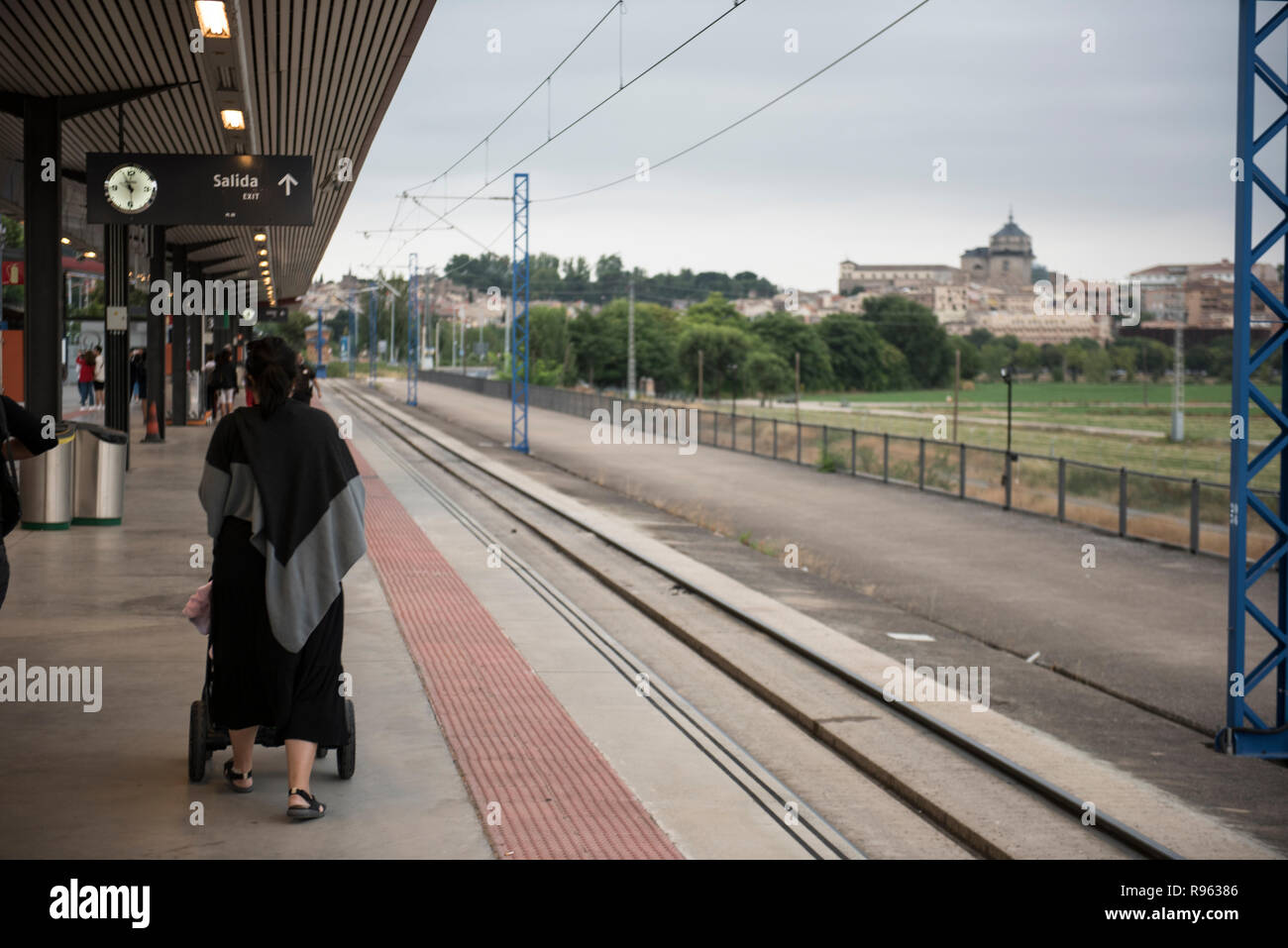 Image of a local Railway station is seen on this closeup. The railway tracks are clealy visible and the passengers are getting ready for train. The sk Stock Photo