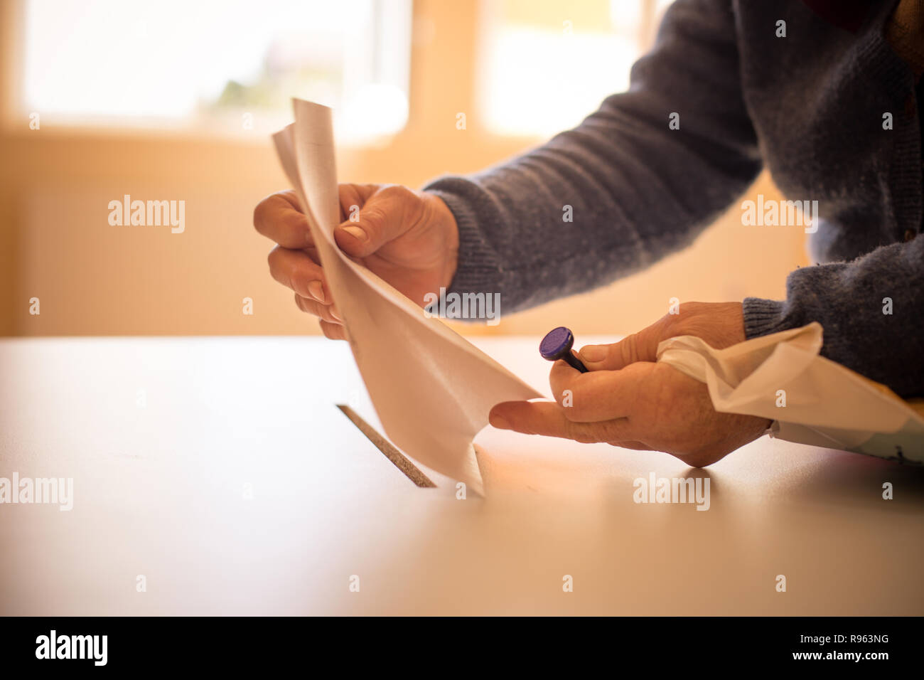 Polling Ballet Color image of a person casting a ballot at a polling station, during ...