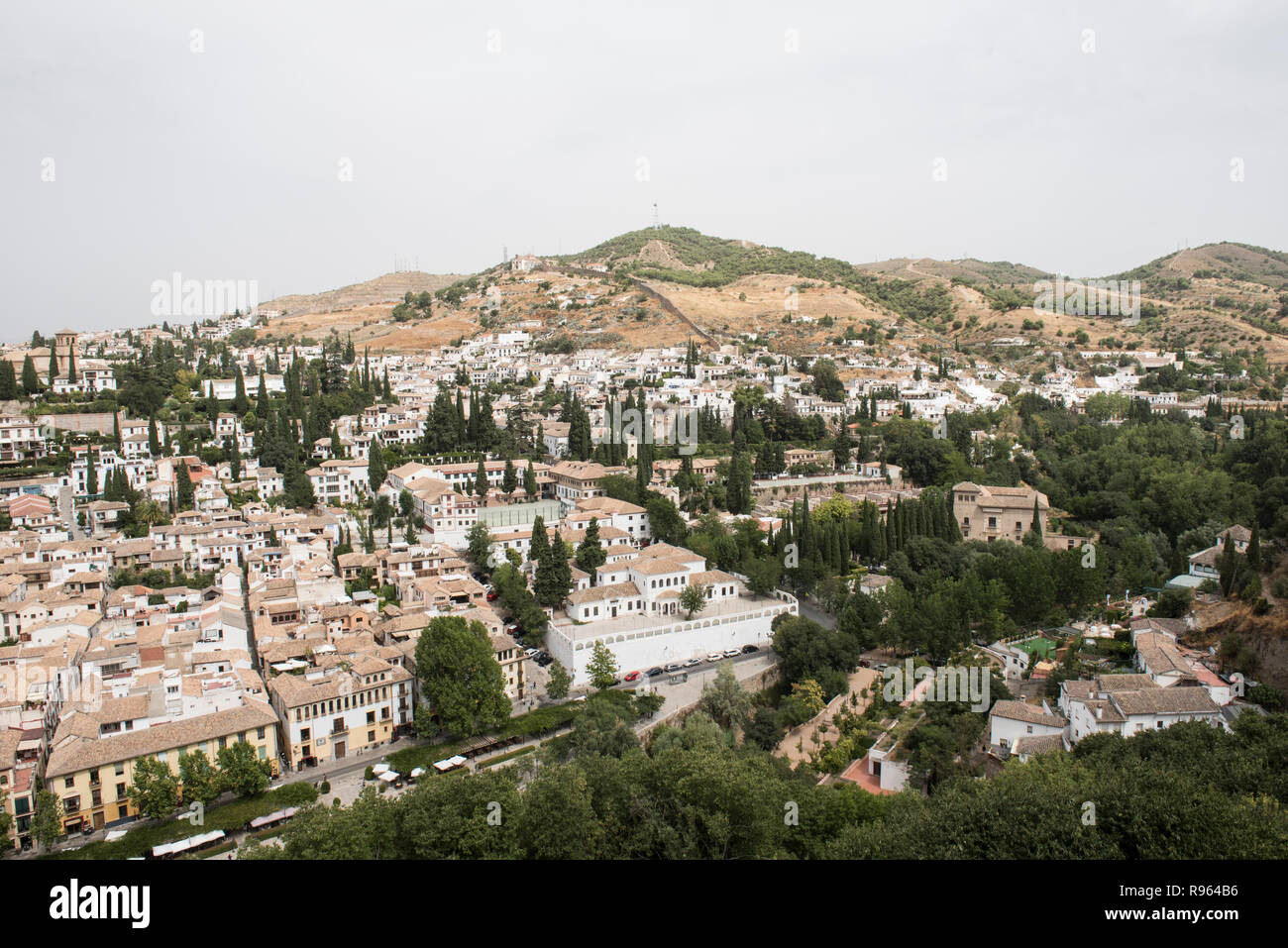 View of the city from the top of Palacio Nazares at Granadda, Spain. The bird's eye view of the city with lush greeneries look amazing. The day seems  Stock Photo