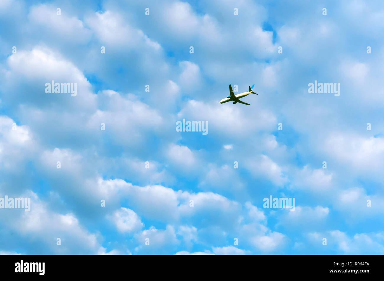 white clouds in the blue sky, plane in the sky Stock Photo - Alamy