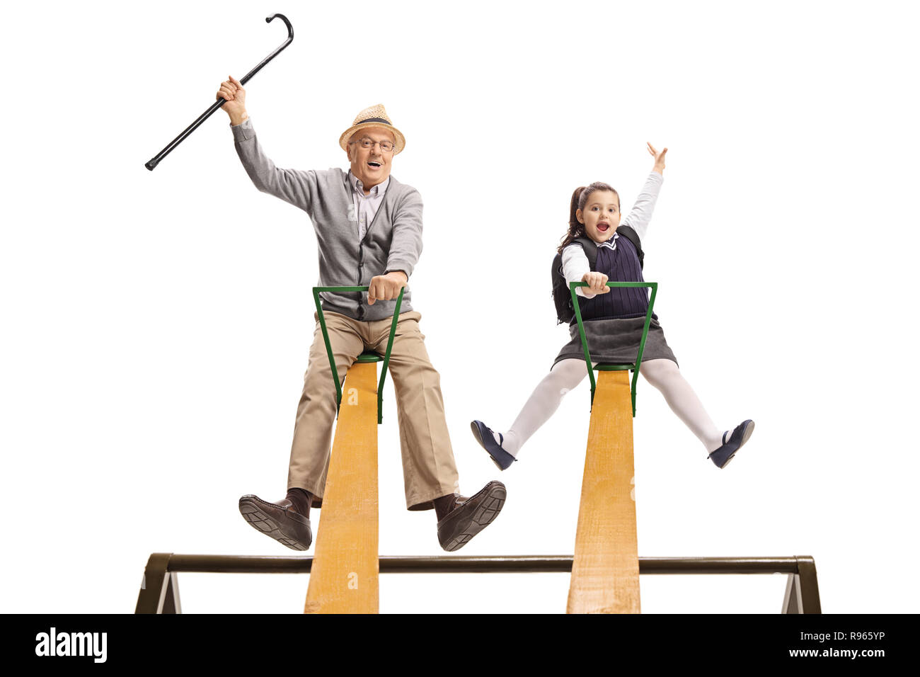 Cheerful grandpa and his granddaughter having fun on a seesaw isolated on white background Stock Photo