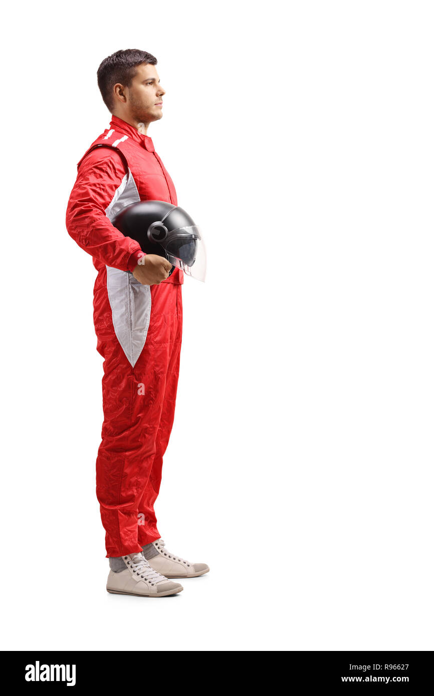 Full length profile shot of a male racer in a red jumpsuit standing and holding a halmet isolated on white background Stock Photo