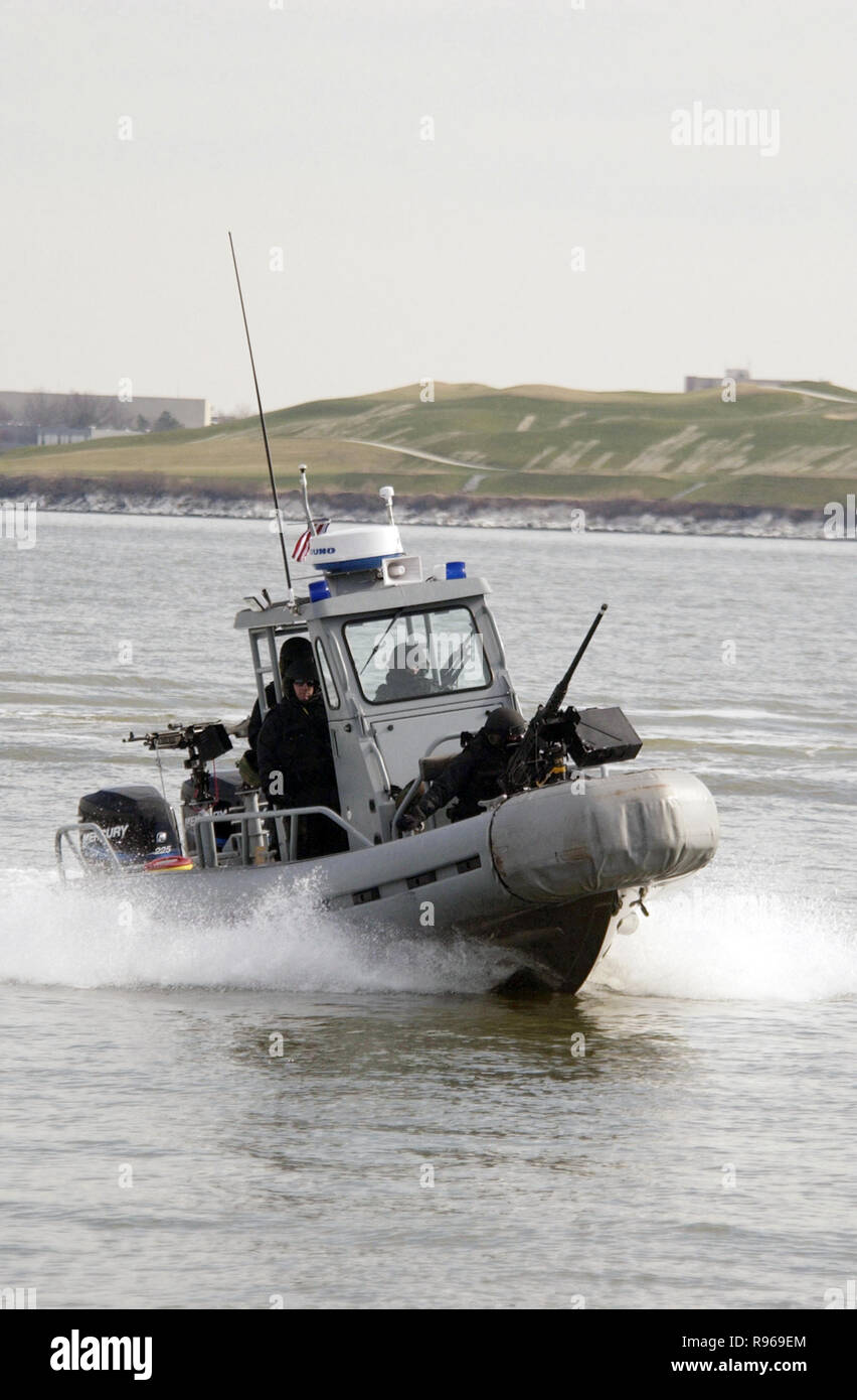 A Navy small craft patrols the exclusion area of the harbor in Portsmouth, Va., during a simulated small boat attack.  The small craft is assigned to Mobile Security Detachment 24. DoD photo by Petty Officer 2nd Class Robert M Schalk, U.S. Navy Stock Photo