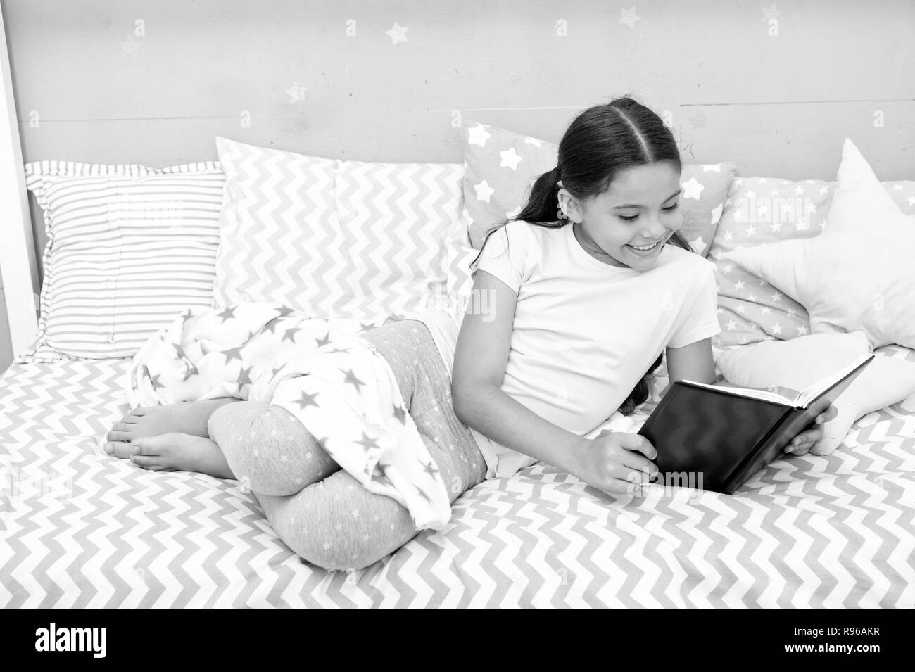 fascinating-story-girl-child-lay-bed-with-pillows-read-book-kid-prepare-to-go-to-bed-time-for