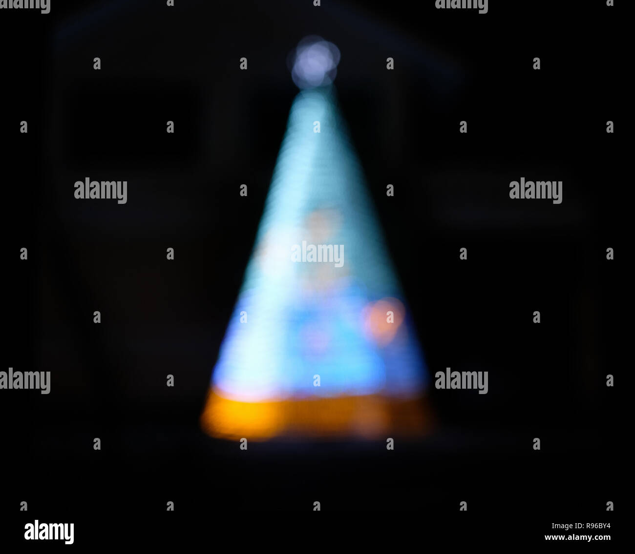 Defocused blue christmas tree on darkness Stock Photo