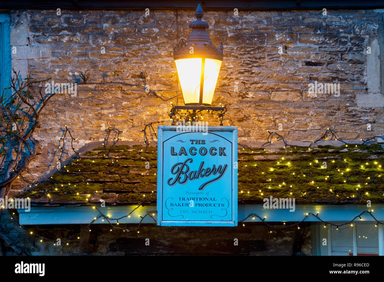 Lacock village bakery detail at night with christmas decorations.  Lacock, Cotswolds, Wiltshire, England Stock Photo