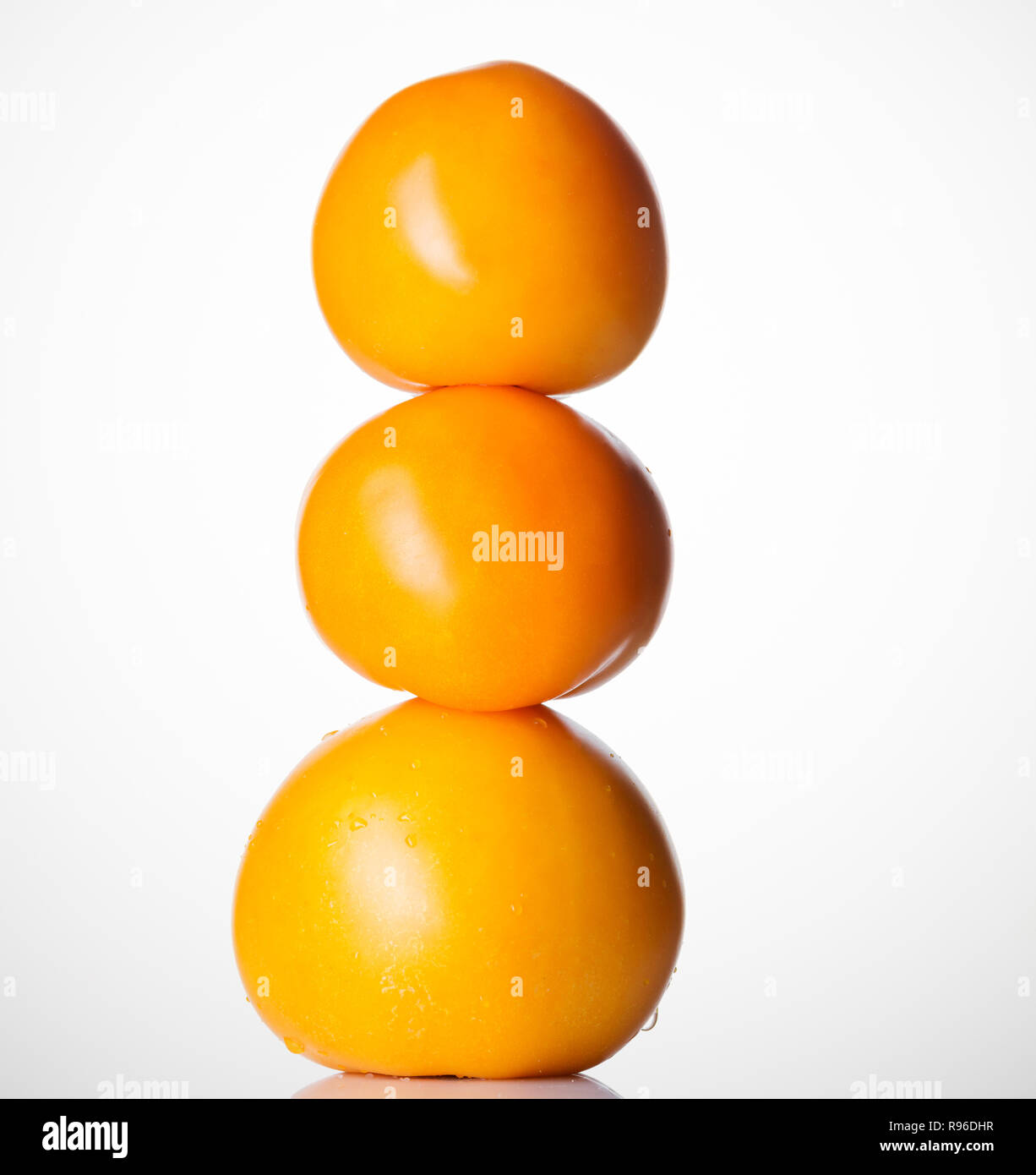Fresh yellow tomatoes isolated on white background. Stock Photo