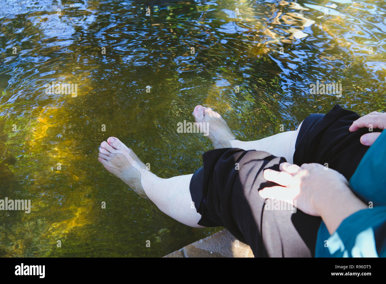 woman soaking feet in hot mineral spring water. healthy lifestyle