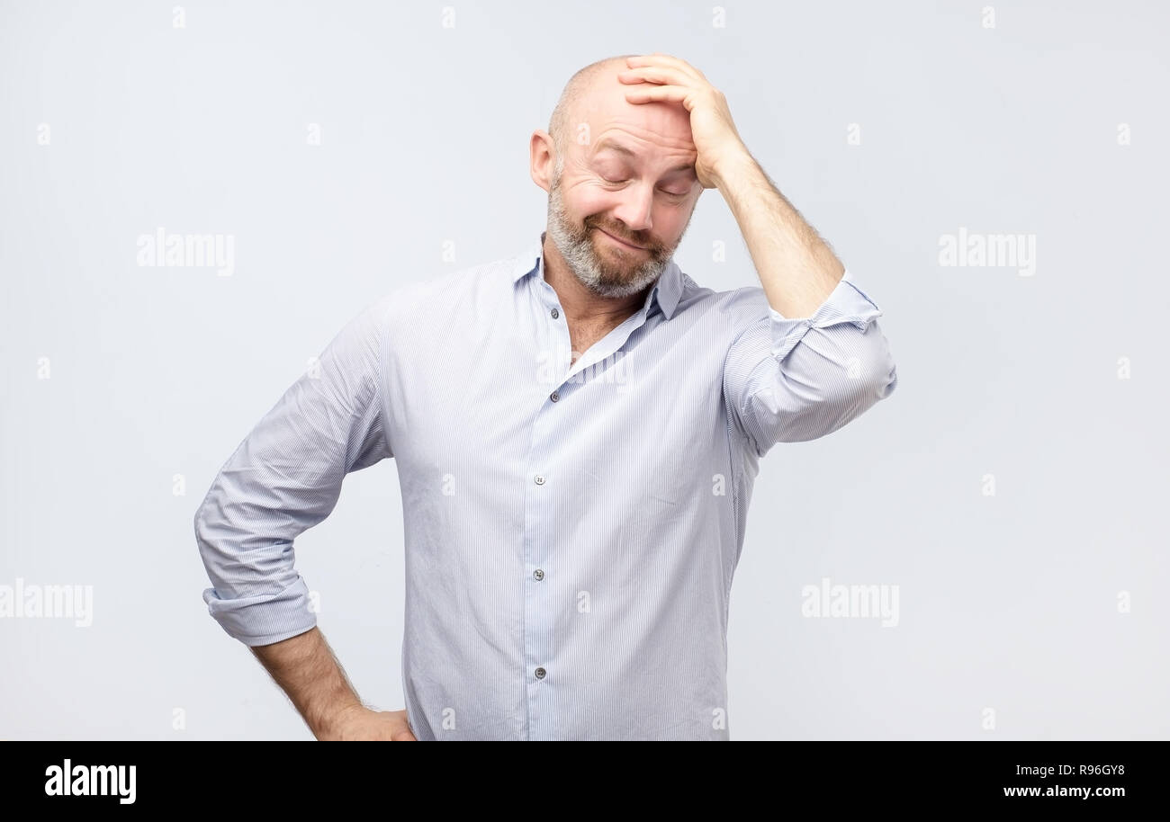 Mature adult in white shirt having a doubt. I am confused and do not know the right way concept Stock Photo