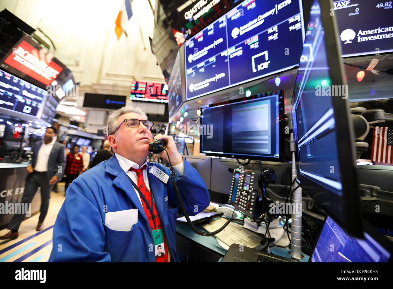 New York, USA. 19th Dec, 2018. A trader works at the New York Stock Exchange in New York, the United States, on Dec. 19, 2018. U.S. stocks ended lower on Wednesday. The Dow fell 1.49 percent to 23,323.66, and the S&P 500 decreased 1.54 percent to 2,506.96, while the Nasdaq was down 2.17 percent to 6,636.83. Credit: Wang Ying/Xinhua/Alamy Live News Stock Photo