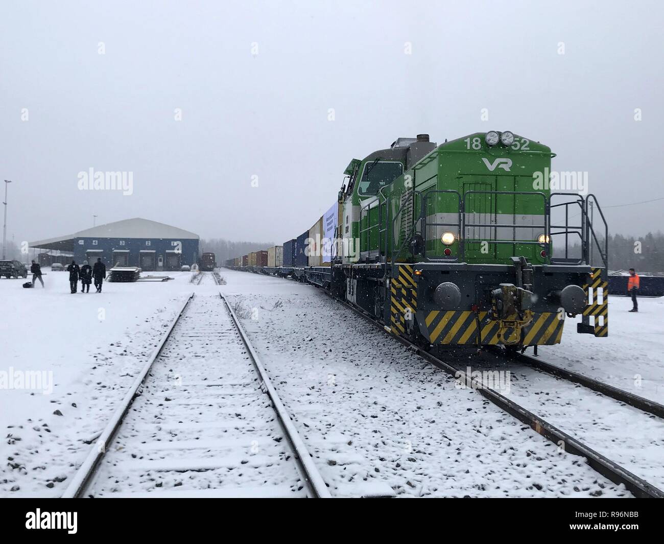 Kouvola. 18th Dec, 2018. Photo taken on Dec. 18, 2018 shows a block train packed with 41 containers of sawn timber in Kouvola, east Finland. The block train left Kouvola on Tuesday for Xi'an, capital of Shaanxi Province in northwest China. It takes two weeks for the 1,800 cubic meters of wood products to arrive in Xi'an, which is playing a bridge head role in opening up the central-west China, said Tommi Saarnisto, product manager of Metsa Fibre which is a prominent forest company of Finland. Credit: Li Jizhi/Xinhua/Alamy Live News Stock Photo