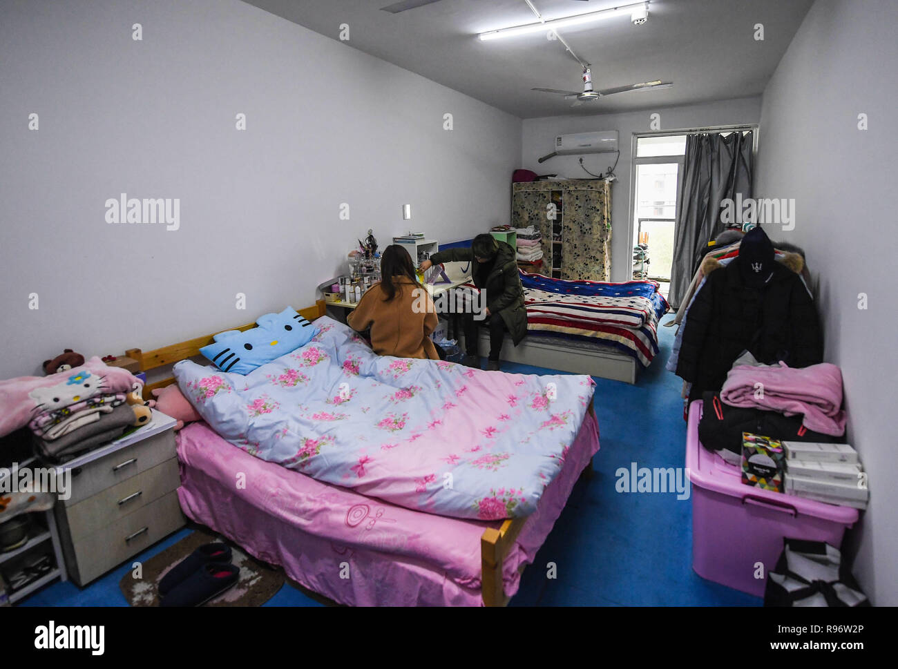 Huzhou. 20th Dec, 2018. Workers rest at their dormitory located at a children's clothing industrial park in Zhili Town of Huzhou City in east China's Zhejiang Province, Dec. 20, 2018. Zhili Town, a major production base for children's clothing, started to improve the living conditions of the dormitories of the children's clothing companies in early 2018 in order to solve the problems of worker shortage and recruitment-difficulty. Credit: Xu Yu/Xinhua/Alamy Live News Stock Photo