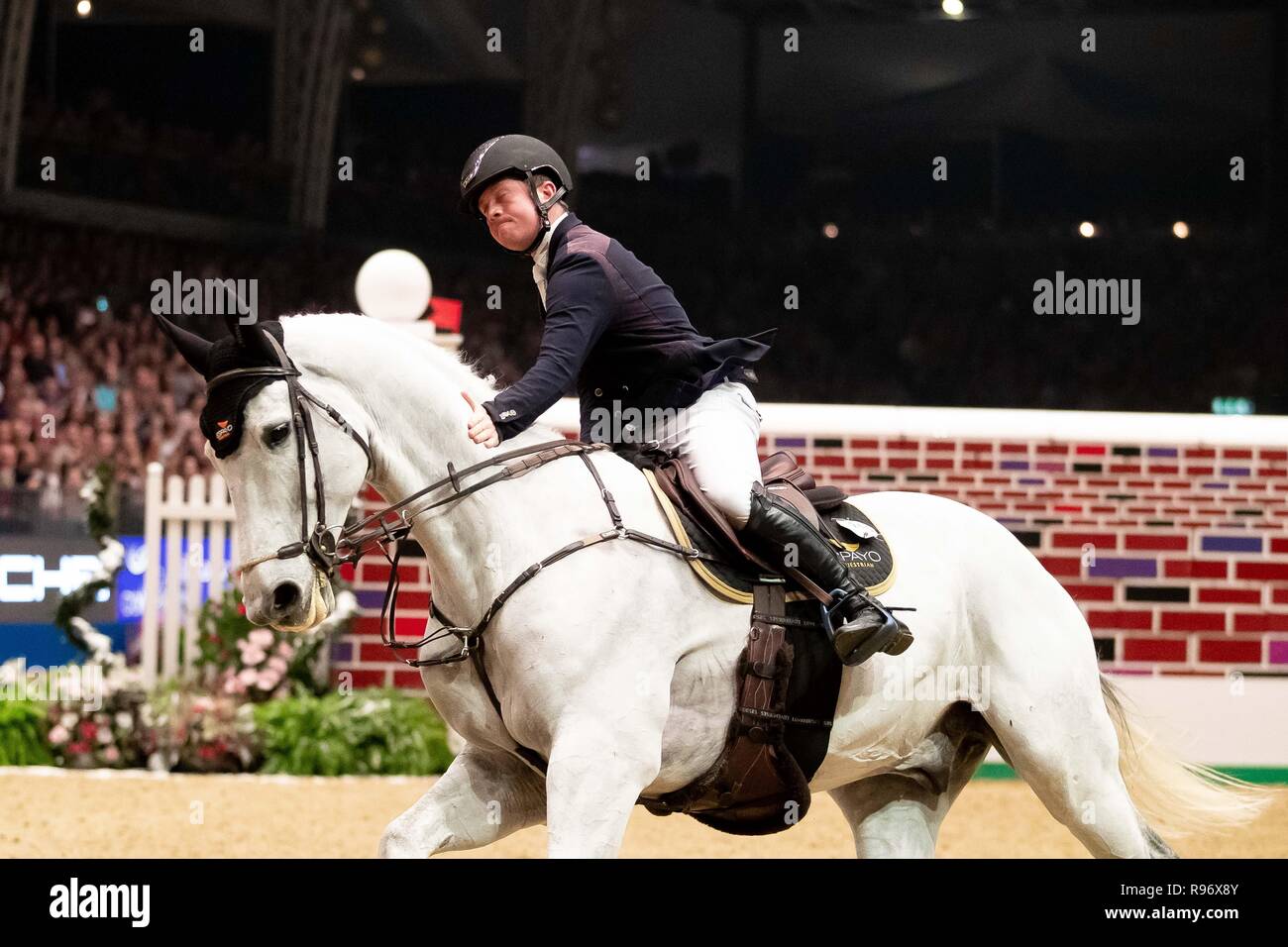 London, UK. 20th December, 2018. Alfie Bradstock riding H. d'Or. GBR. Puissance. Showjumping. Olympia. The London International Horse Show. London. UK. Credit: Sport In Pictures/Alamy Live News Stock Photo