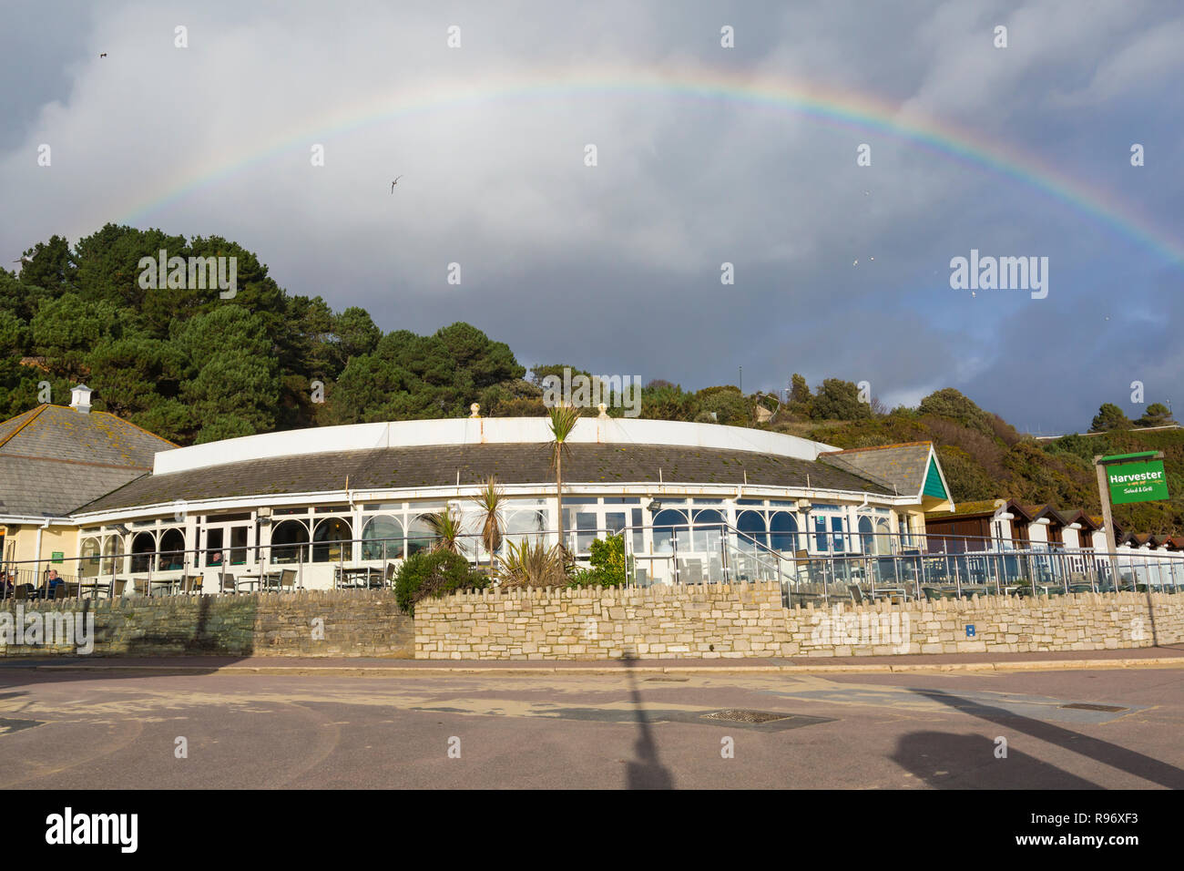 Bournemouth, Dorset, UK. 20th December 2018. Rainbow over Bournemouth on a mainly sunny day. Rainbow over the Durley Inn Harvester chain pub restaurant, exterior at West Undercliff Promenade. Credit: Carolyn Jenkins/Alamy Live News Stock Photo