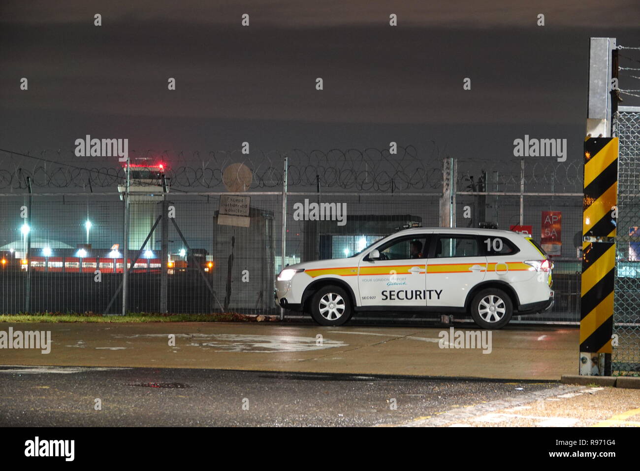 London Gatwick, UK. 20th December, 2018. Gatwick Airport Security vehicle guards runway with control tower behind on Thursday night, as drone activity causes the airport to close for over 24 hours. Credit: Andy Stehrenberger/Alamy Live News Stock Photo