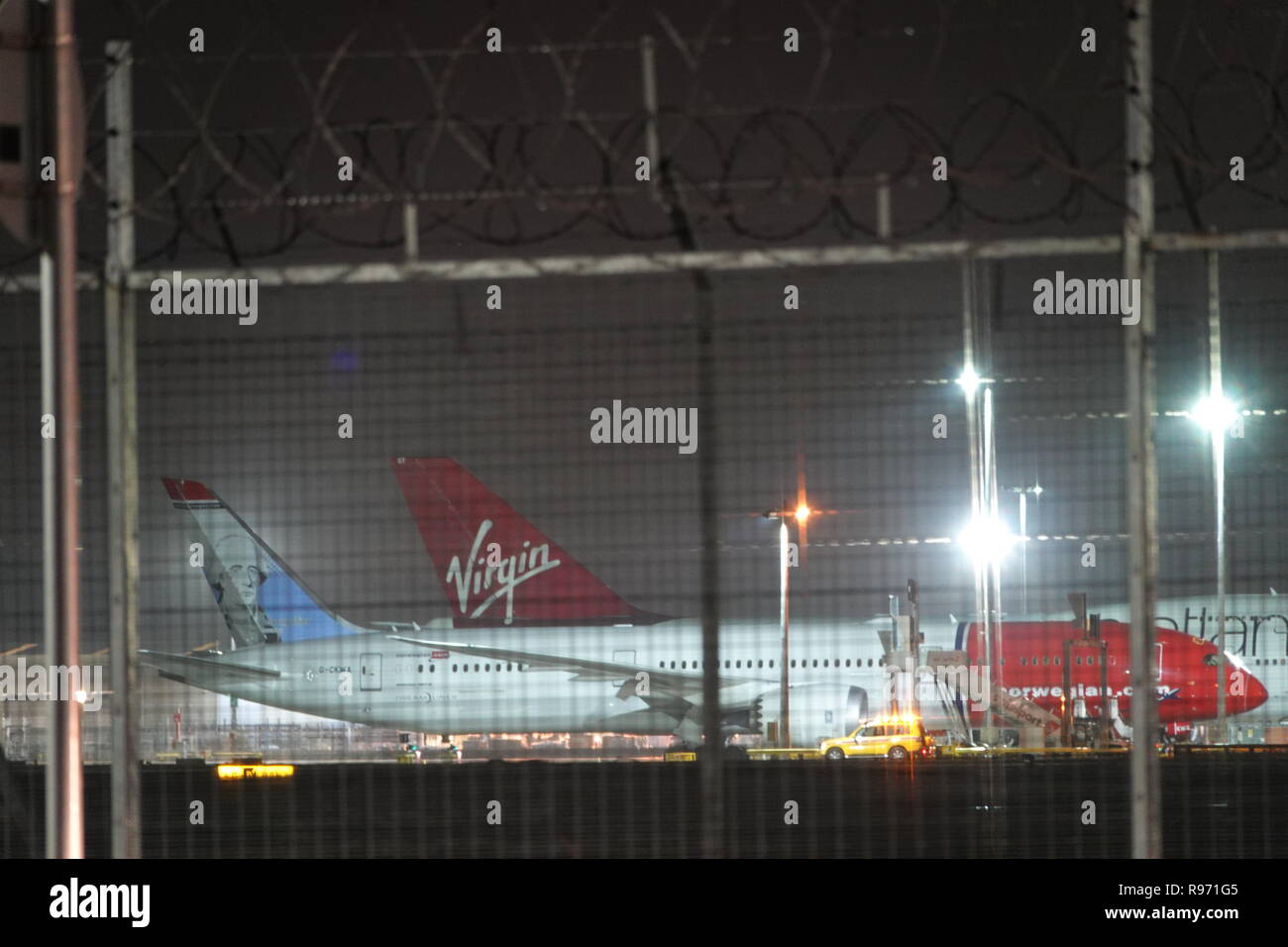 London Gatwick, UK. 20th December, 2018. Passenger jet airplanes grounded at Gatwick Airport on Thursday night, as drone activity causes the airport to close for over 24 hours. Credit: Andy Stehrenberger/Alamy Live News Stock Photo