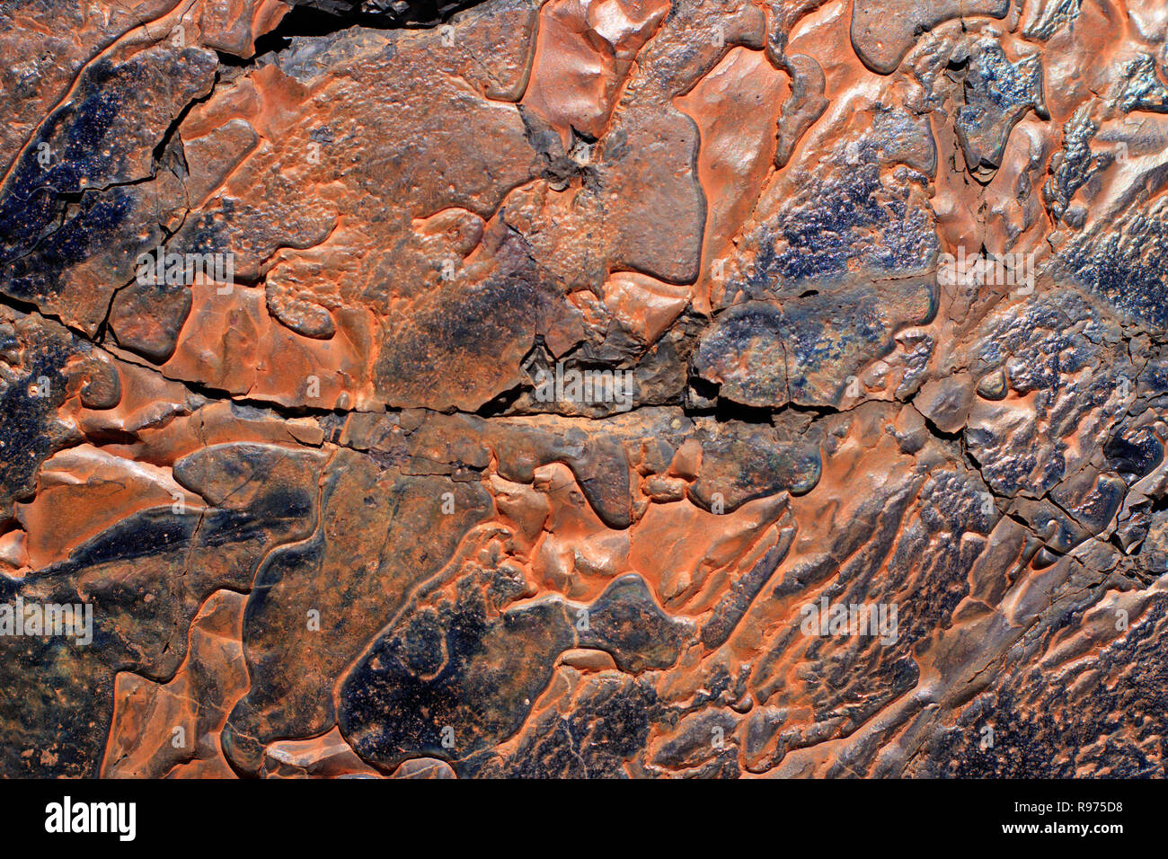 Abstract design of the side of a copper smelter slag heap showing once molten ore background with copy space Stock Photo