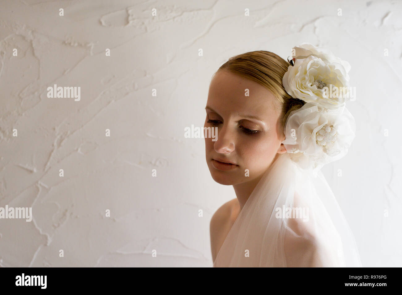 Caucasian female model poses for wedding pictures in the studio Stock Photo