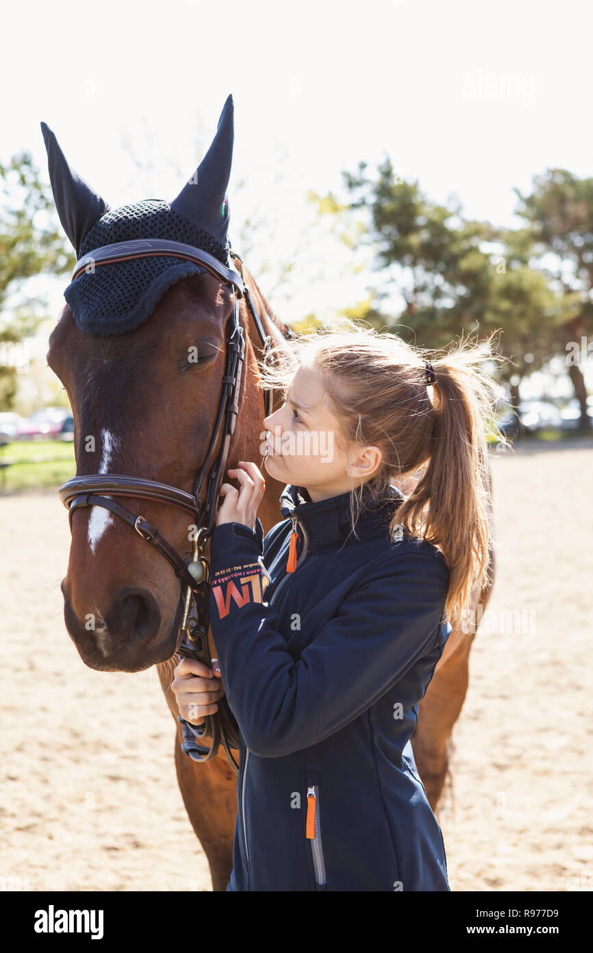 Teenage girl and a horse in Sweden Stock Photo