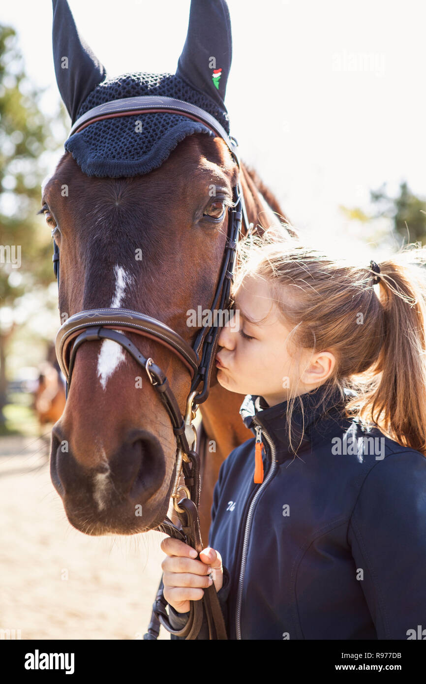 Teenage girl kissing a horse in Sweden Stock Photo