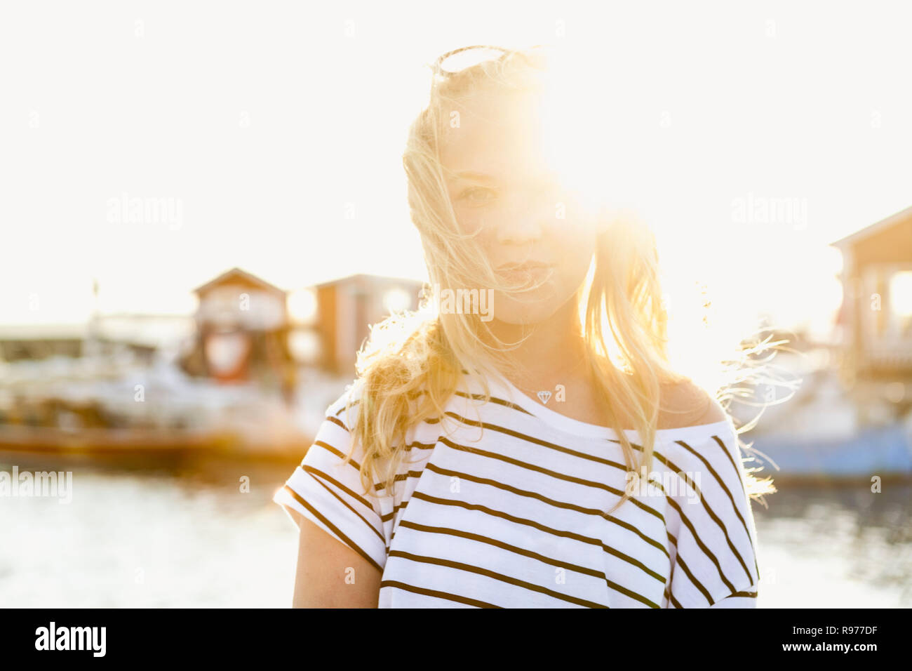 Teenage girl standing at the harbor in Hano, Sweden Stock Photo