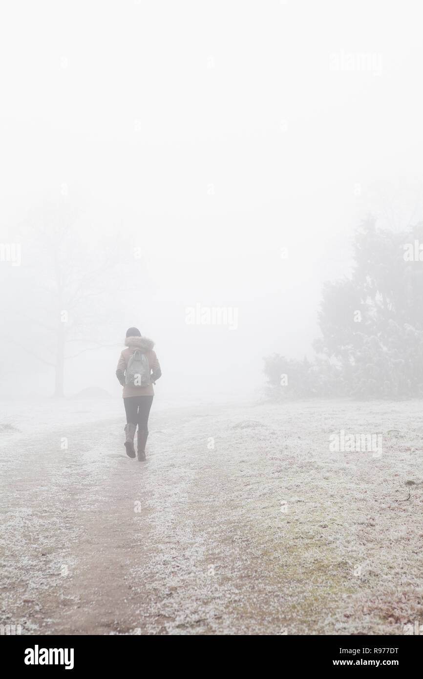 Teenage girl walking through mist in Blekinge, Sweden Stock Photo