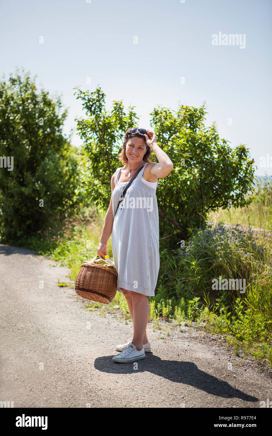 Woman with picnic basket in Blekinge, Sweden Stock Photo