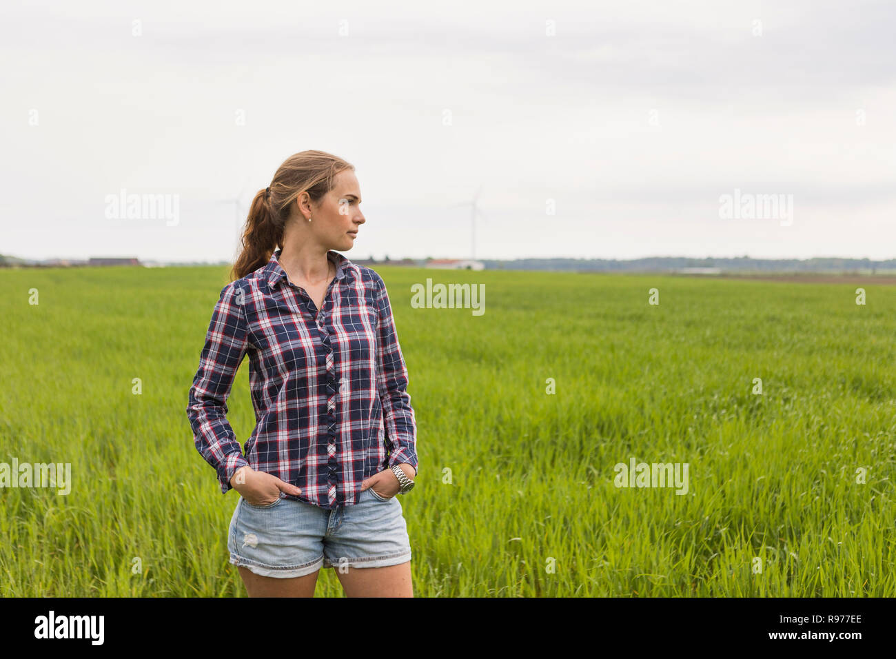 Agricultural worker standing in a field Stock Photo