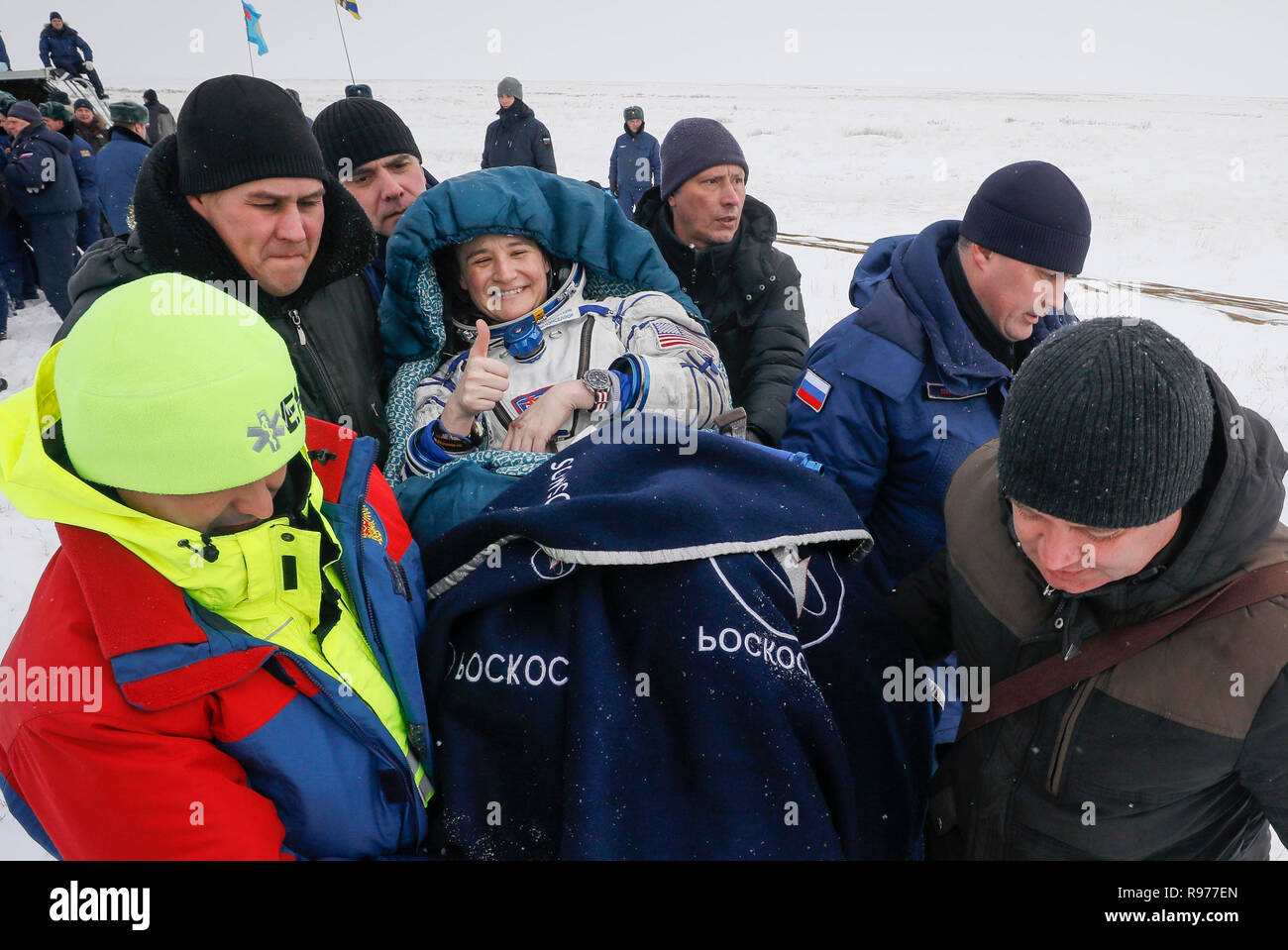 Ground personnel help NASA's Serena Aunon-Chancellor after landing in a remote area outside the town of Zhezkazgan, formerly known as Dzhezkazgan, Kazakhstan, on Thursday, Dec. 20, 2018. Three astronauts have returned to Earth after more than six months aboard the International Space Station. (Shamil Zhumatov/Pool via AP) Stock Photo