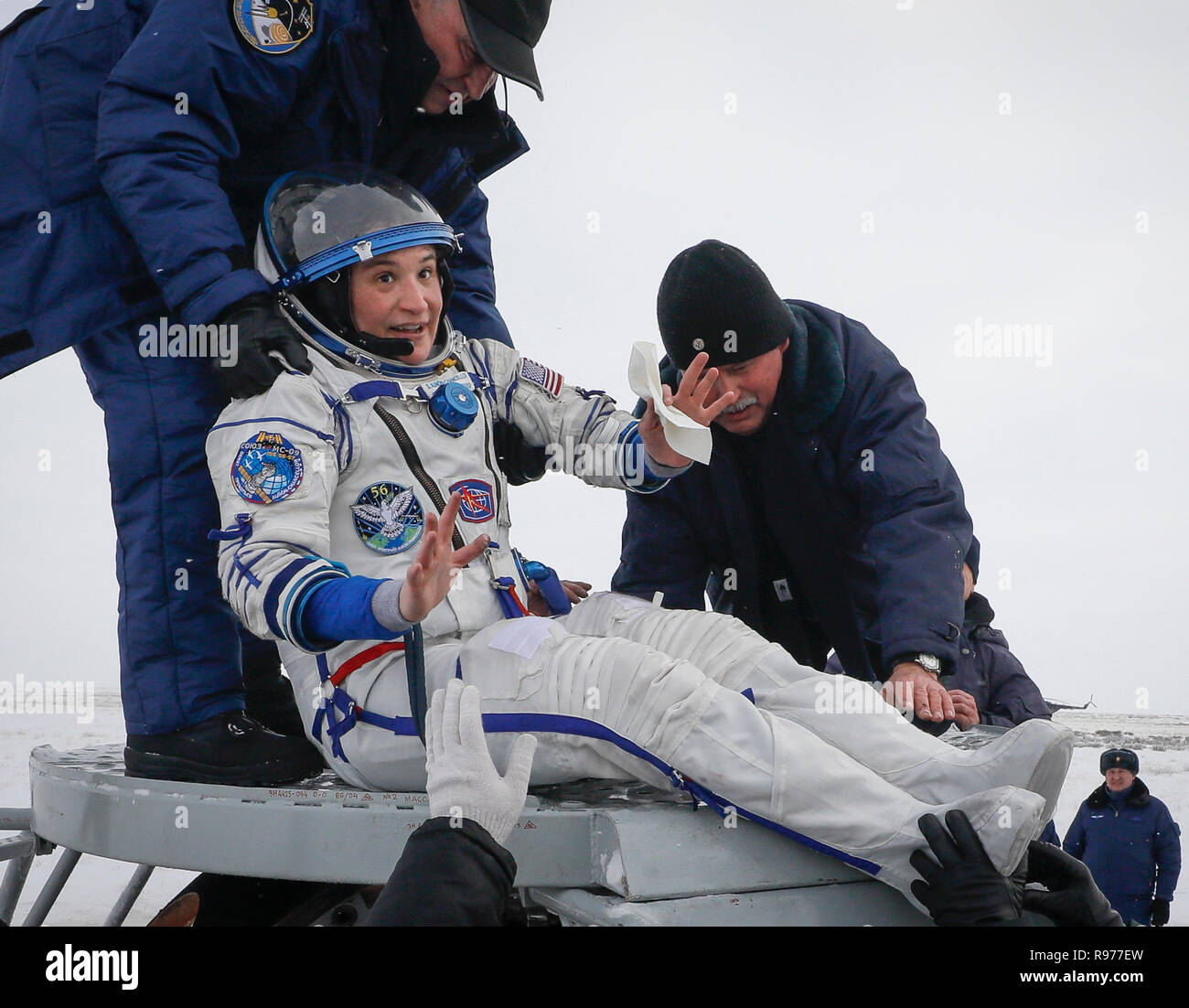 Ground personnel help NASA's Serena Aunon-Chancellor to get out of capsule after landing in a remote area outside the town of Zhezkazgan, formerly known as Dzhezkazgan, Kazakhstan, on Thursday, Dec. 20, 2018. Three astronauts have returned to Earth after more than six months aboard the International Space Station. (Shamil Zhumatov/Pool via AP) Stock Photo