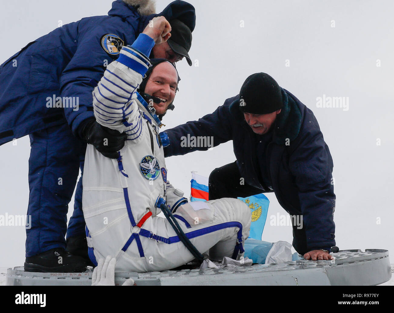 Ground personnel help International Space Station (ISS) crew member astronaut Alexander Gerst, of Germany, to get out of capsule after landing in a remote area outside the town of Zhezkazgan, formerly known as Dzhezkazgan, Kazakhstan, on Thursday, Dec. 20, 2018. Three astronauts have returned to Earth after more than six months aboard the International Space Station. (Shamil Zhumatov/Pool Photo via AP) Stock Photo