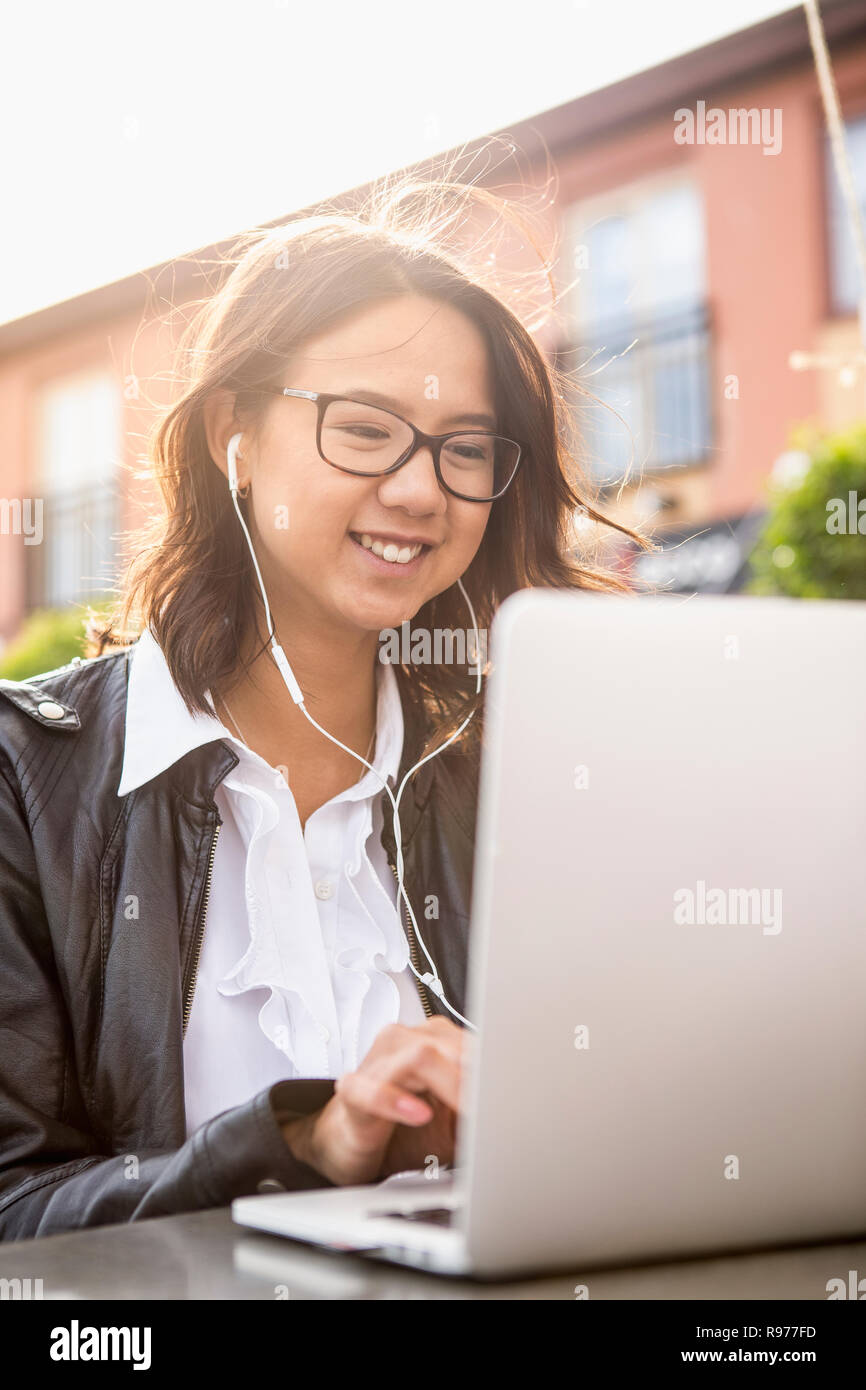 Young woman using her laptop in Solvesborg, Sweden Stock Photo