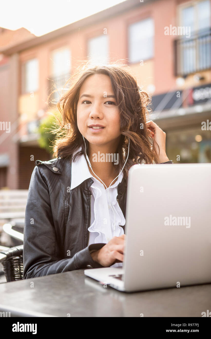 Young woman using her laptop in Solvesborg, Sweden Stock Photo