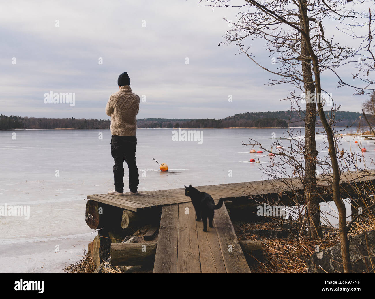 Man standing by water in Kloverget, Sweden Stock Photo