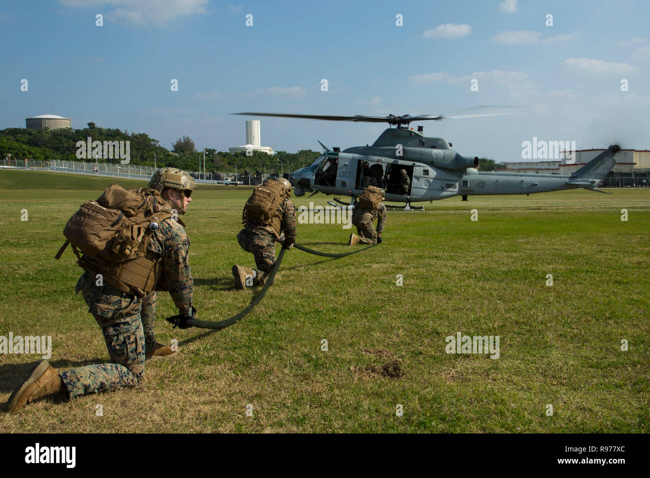 U.S. Marines with subordinate commands under III Marine Expeditionary Force prepare to conduct Special Patrol Insertion and Extraction and Helicopter Rope Suspension Techniques training on Camp Hansen, Okinawa, Japan, Dec. 18, 2018. SPIE rigging, fast roping, and rappelling allow Marines to enter and exit landing zones that are too dangerous for helicopters to safely land on. SPIE and HRST training teach Marines proper knots and rappelling techniques, and builds confidence in maneuvering from air to ground. (U.S. Marine Corps photo by Lance Cpl. Kenny Nunez) Stock Photo