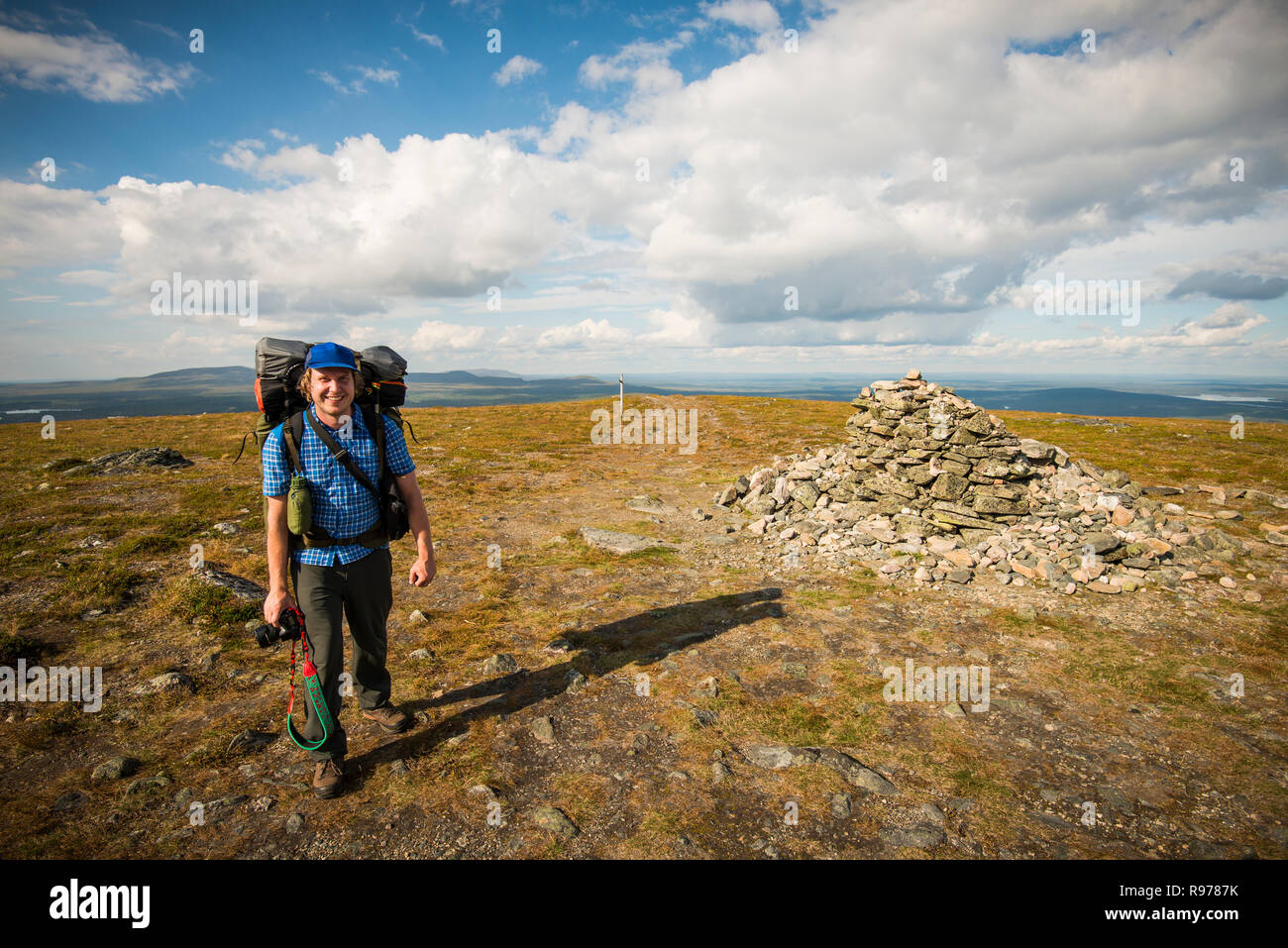 Man standing on top of a hill at Pallas-Yllastunturi National Park ...