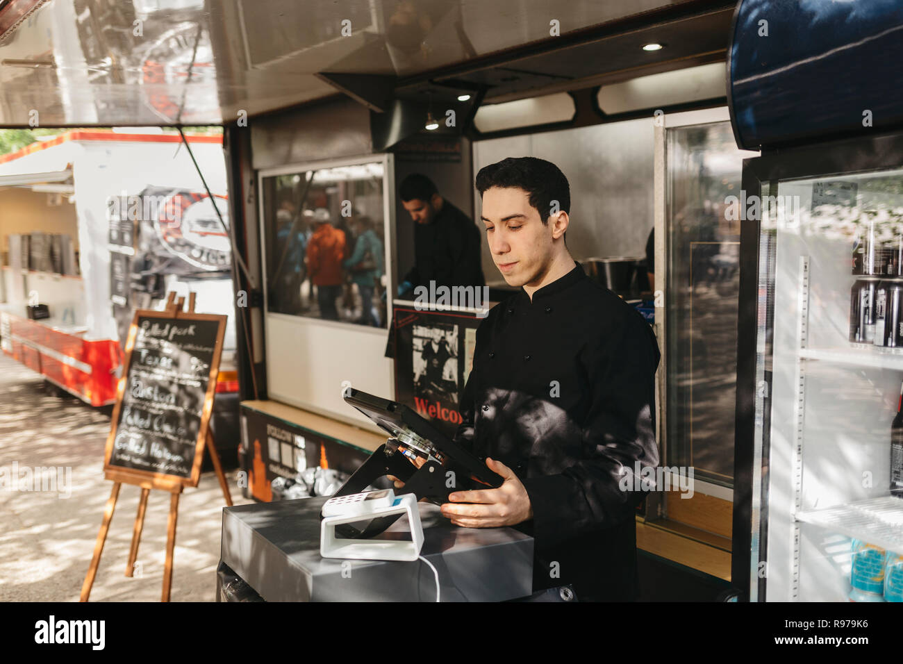 Food truck worker managing the cash register Stock Photo Alamy